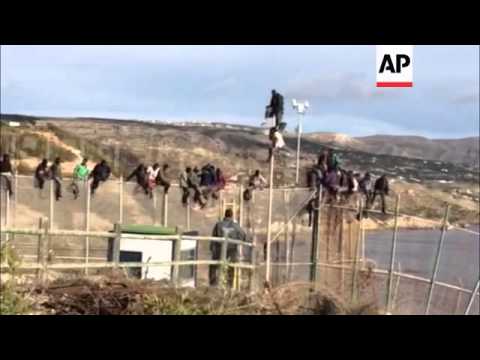 Illegal migrants scale border fence between Morocco and Spanish enclave