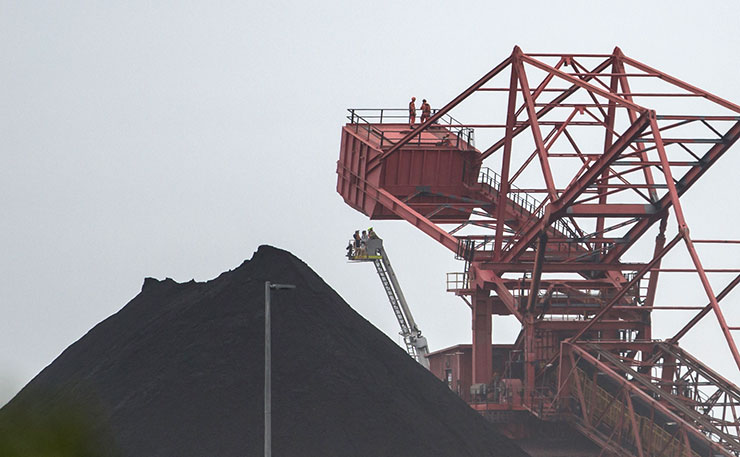 FILE IMAGE: Protestor have locked onto a coal loader at Port Kembla, Wollongong. (IMAGE: Flood The System Australia, Flickr)