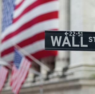 A Wall Street sign hangs near the New York Stock Exchange.