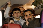 Refugees stand inside a bus arriving from the Bavarian town of Landshut to the Chancellery building in Berlin, Germany, January 14, 2016