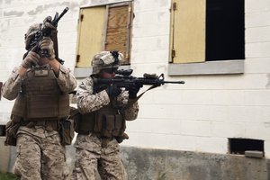 File - Marines with Light Armored Reconnaissance, Battalion Landing Team 2/6, 26th Marine Expeditionary Unit, clear the street of a Military Operations in Urban Terrain (MOUT) training town at Fort Pickett, Va., April 16, 2016.