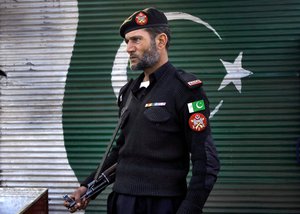 File - A police officer stands guard close to the site of a suicide attack, in Peshawar, Pakistan, Tuesday, Jan. 19, 2016.