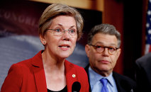 Sen. Elizabeth Warren, D-Mass, left, speaks at a new conference on Capitol Hill in Washington.