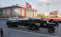 Missiles are taken on trucks past a stand with North Korean leader Kim Jong Un during the parade celebrating the 70th anniversary of the founding of the ruling Workers' Party of Korea, in Pyongyang October 10, 2015