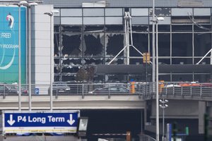 The blown out windows of Zaventem airport are seen after a deadly attack in Brussels, Belgium, Tuesday, March 22, 2016.