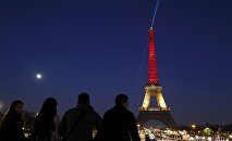 The Eiffel Tower is seen with the black, yellow and red colours of the Belgian flag in tribute to the victims of today's Brussels bomb attacks in Paris.