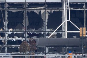 The blown out windows of Zaventem airport are seen after a deadly attack in Brussels, Belgium, Tuesday, March 22, 2016.