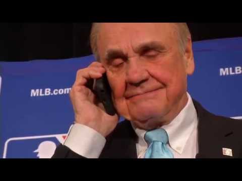 Dick Enberg is congratulated by Vin Scully over the phone for his Frick Award