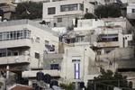 File - In this Monday, Oct. 19, 2015, photo, an Israeli flag hangs on the wall of a building that was taken over by Israeli settlers after Palestinian families were evicted in the Silwan neighborhood of east Jerusalem.