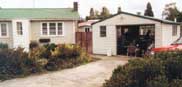 The new Headquarters of the Party at Manurewa.
On the left can be seen the cottage; 
at right, a meeting is under way in the spacious garage.