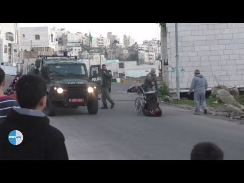 Israeli soldier throws a disabled Palestinian out of his wheelchair