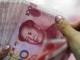 In this Tuesday, Aug. 11, 2015 photo, a bank clerk counts Chinese currency notes at a bank outlet in Huaibei in central China's Anhui province. Chinas surprise move on Tuesday to devalue its currency has intensified concerns about a slowdown in the worlds second-largest economy, whose growth rate has reached a six-year low. It is also fanning tensions with the United States and Europe, whose exports could become comparatively costlier. (Chinatopix via AP) CHINA OUT