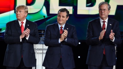 Republican presidential candidates (L-R) businessman Donald Trump, Texas Sen. Ted Cruz, and  former Gov. Florida Jeb Bush clap before the start of the Republican Presidential Debate, hosted by CNN, at The Venetian Las Vegas on December 15, 2015 in Las Vegas, Nevada.  AFP PHOTO / ROBYN BECK / AFP / ROBYN BECK        (Photo credit should read ROBYN BECK/AFP/Getty Images)