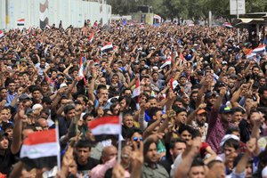 Followers of Shiite cleric Muqtada al-Sadr protest outside the heavily guarded Green Zone in Baghdad, Iraq, Friday, March 25, 2016. IS killed around three dozen people on Friday night at a soccer match.