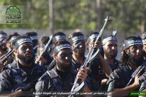 FILE - In this file image posted on the Twitter page of Ahrar al-Sham on June. 19, 2015, fighters from Ahrar al-Sham march in the eastern Damascus suburb of Ghouta, Syria.