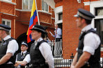 Surrounded by British police WikiLeaks founder Julian Assange, centre, makes a statement to the media and supporters from a window of Ecuadorian Embassy in central London.