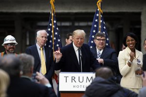 Alicia Watkins of Gaithersburg, Md., right, smiles as she talks to Republican presidential candidate Donald Trump after asking him for a job, while he was speaking during a campaign event in the atrium of the Old Post Office Pavilion, soon to be a Trump International Hotel, Monday, March 21, 2016, in Washington.