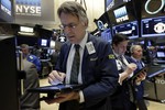 Trader Joseph Chirico, left, works on the floor of the New York Stock Exchange, Friday, March 18, 2016. U.S. stocks opened higher again, setting the market up to extend its winning streak to a fifth week and erasing most of the year's early losses