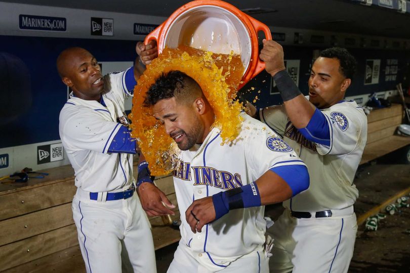 SEATTLE, WA - JULY 26:  Franklin Gutierrez #30 of the Seattle Mariners is doused by teammates after hitting a walk-off home run to defeat the Toronto Blue Jays 6-5 in ten innings at Safeco Field on July 26, 2015 in Seattle, Washington.