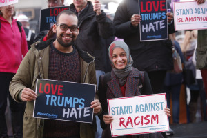 "NEW YORK, NY - MARCH 16:  Ben O'Keefe and Iram Ali of MoveOn.org Political Action stand outside the studios of "Good Morning America" to broadcast messages of love, dignity, and equality and stand up against the hate, racism, and incitement of violence that the group says has become a hallmark of Donald Trump's presidential campaign in New York City on Wednesday, March 16, 2016 in New York City. (Photo by Thos Robinson/Getty Images for MoveOn.org Political Action)"