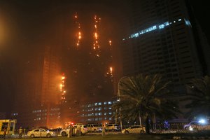 Fire and smoke billow from a high-rise building in Ajman, United Arab Emirates, early Tuesday, March 29, 2016.