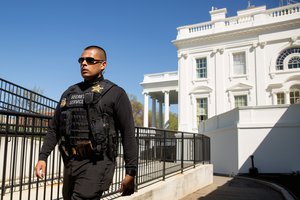 A member of the uniformed Secret Service walks near the press briefing room and the North Lawn of the the White House in Washington, Monday, March 28, 2016, after a U.S. Capitol Police officer was shot Monday at the Capitol Visitor Center complex, and the shooter was taken into custody.