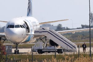 A man leaves the hijacked aircraft of Egyptair at Larnaca airport Tuesday, March 29, 2016.