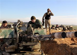 In this Tuesday, Jan. 20, 2015 image released by the Kurdistan Region Security Council (KRSC), Kurdish peshmerga forces prepare their positions on the front line for battle against Islamic State group positions in northern Iraq.