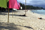 A man sunbathes under the shades on the white beach at Boracay, Philippines as seen in this March 11, 2009 photo.