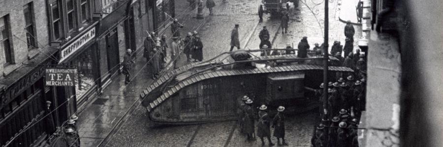 A British Army Mark V tank rams a sealed premises on Capel Street, Dublin, January 18th 1921, during destructive house-searches by the UK Occupation Forces in Ireland