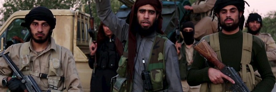 A man (C) identified in the subtitiles as Al Karar the Iraqi gestures as he speaks at an undisclosed location in this image taken from undated video footage released by Islamic State. Islamic State warned in the new video on November 16, 2015 that countries taking part in air strikes against Syria would suffer the same fate as France, and threatened to attack in Washington. The video, which appeared on a site used by Islamic State to post its messages, begins with news footage of the aftermath of Friday's Paris shootings in which at least 129 people were killed. REUTERS/Social Media Website via Reuters TVATTENTION EDITORS - THIS PICTURE WAS PROVIDED BY A THIRD PARTY. REUTERS IS UNABLE TO INDEPENDENTLY VERIFY THE AUTHENTICITY, CONTENT, LOCATION OR DATE OF THIS IMAGE. THIS PICTURE IS DISTRIBUTED EXACTLY AS RECEIVED BY REUTERS, AS A SERVICE TO CLIENTS. FOR EDITORIAL USE ONLY. NOT FOR SALE FOR MARKETING OR ADVERTISING CAMPAIGNS. NO RESALES. NO ARCHIVE.      TPX IMAGES OF THE DAY