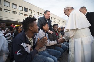 Pope Francis greets migrants during his visit at the Castelnuovo di Porto refugees center, some 30km (18, 6 miles) from Rome, Thursday, March 24, 2016.