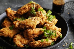 Neil Perry's fried chicken wings with honey and sesame glaze.