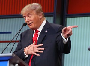 Republican presidential candidate Donald Trump responds to former Arkansas Gov. Mike Huckabee's closing remarks during the first Republican presidential debate at the Quicken Loans Arena Thursday, Aug. 6, 2015, in Cleveland.