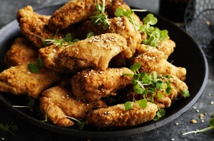 Neil Perry's fried chicken wings with honey and sesame glaze.