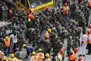 Indian soldiers and rescue workers work on a partially collapsed overpass in Kolkata, India,Thursday, March 31, 2016.