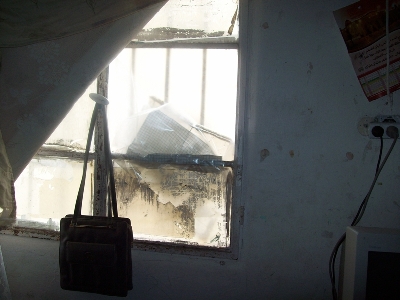 Broken window in a house in Awarta