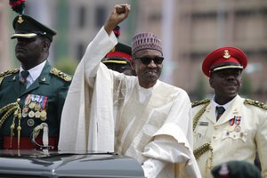 New Nigerian President, Muhammadu Buhari, salutes his supporters during his Inauguration in Abuja, Nigeria, Friday, May 29, 2015. Nigerians celebrated their newly reinforced democracy Friday, dancing and singing songs and praises at the inauguration of Muhammadu Buhari, the first candidate to beat a sitting president at the polls.