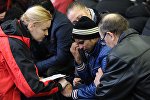 A psychologist of the Russian Emergencies Ministry speaks with a relative of a victim of the crashed Flydubai Boeing 737-800 at the airport of Rostov-On-Don, Russia