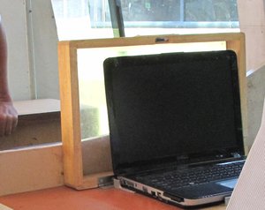 A man (unseen) watching the blank screen of a laptop computer.