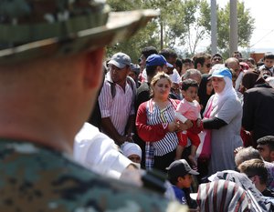 Refugees at the  Greece-Macedonia border barrier 24 August 2015