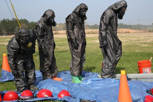 File - Soldiers perform self-decontamination procedures during a chemical, biological, radiological and nuclear defense training exercise at the Joint Readiness Training Center on Fort Polk, La., March 15, 2016.