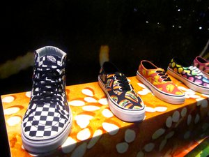 Colorful Vans sneakers on display.