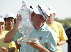 Jim Herman kisses the winner's trophy after winning the Houston Open golf tournament, Sunday, April 3, 2016, in Humble, Texas.