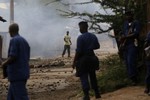 A demonstrator faces police in the Musaga neighborhood of Bujumbura, Burundi, Wednesday May 20, 2015.