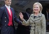 Former U.S. Secretary of State Hillary Rodham Clinton waves to the media after a meeting with French President Francois Hollande at the Elysee Palace in Paris, Tuesday, July 8, 2014.