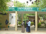 Privately sponsored students stand at the entrance of the recently reopened Garissa university college, in Garissa, Kenya, Monday, Jan. 4, 2016.