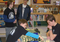 Derek Johnson checkmates Andrew Slagle in the tournament’s third round as Tanner Martin and Brady Hornstra, who would play for the title, look on. (Calvin Bratt/Lynden Tribune)