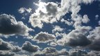 Cumulus clouds covering sun in sky 