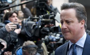 File - British Prime Minister David Cameron, right, arrives for an EU summit in Brussels on Thursday, March 17, 2016.